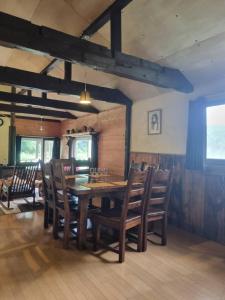 a dining room with a wooden table and chairs at Bears House in Furano