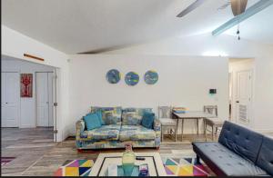 a living room with a couch and a table at Peace On The Beach House in Panama City Beach