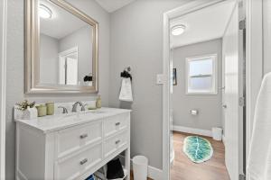 a white bathroom with a sink and a mirror at Tranquil Retreat: Cozy 2Bed, 1Bath Oasis in Fallon in Fallon +18 photos