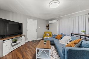 a living room with a blue couch and a tv at Tranquil Retreat: Cozy 2Bed, 1Bath Oasis in Fallon in Fallon