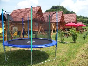 a trampoline in a yard in front of a house at Domki nad Soliną DAGA in Solina