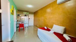 a small bedroom with a bed and a kitchen at Vg Fun by Diego Flats in Fortaleza