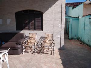 2 sedie e un divano su un patio di Casa da San a Mongaguá