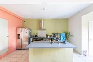 a kitchen with a refrigerator and a counter top at DICI Co-Living Housing Cabo San Lucas in Cabo San Lucas