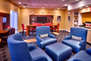 a waiting room with blue chairs and a table at TownePlace Suites by Marriott Missoula in Missoula