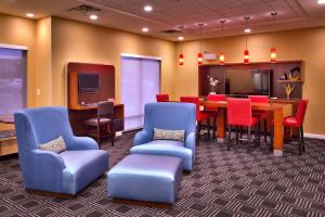 a waiting room with chairs and a table and a dining room at TownePlace Suites by Marriott Missoula in Missoula