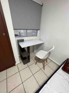 a small room with a desk and a white chair at Casa Tulum in Villa del Pueblito