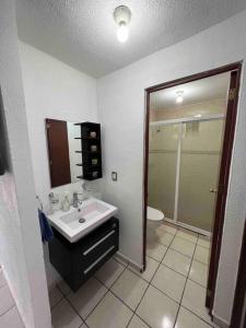 a bathroom with a sink and a toilet at Casa Tulum in Villa del Pueblito