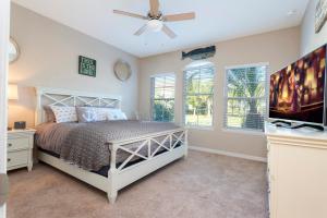 a bedroom with a bed and a ceiling fan at Luxury Family Villa 4 BR with 3 King Beds & Pool in Davenport