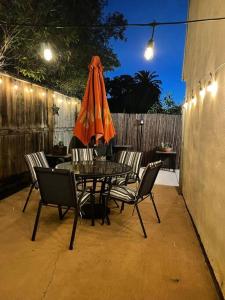 a patio with a table and chairs and an umbrella at Santa Barbara Serenity Large 1-bedroom Guest Apt. in Santa Barbara