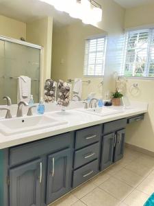 a bathroom with two sinks and a large mirror at Santa Barbara Serenity Large 1-bedroom Guest Apt. in Santa Barbara