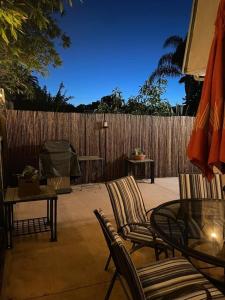 a patio with chairs and a table and a fence at Santa Barbara Serenity Large 1-bedroom Guest Apt. in Santa Barbara