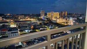 a view of a city at night from a balcony at SLEPTOPIA PREMIUM UNIT WITH TWIN QUEEN BED in Nagoya