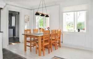 a dining room with a wooden table and chairs at Stunning Home In Klssbol With Kitchen in Klässbol