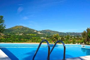 a swimming pool with a view of a mountain at Casa De Santa Comba in Cabeceiras de Basto