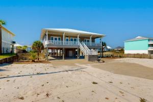 une grande maison sur la plage avec une allée. dans l'établissement Gulfside Bliss, à Navarre