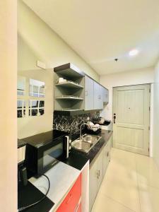 a kitchen with a sink and a black counter top at *Top Choice Awardee B 2023 in Iloilo City +9 photos