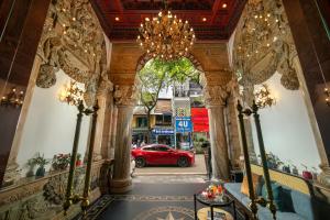 a red car parked in a building with a chandelier at Media Central Hotel & Spa in Hanoi