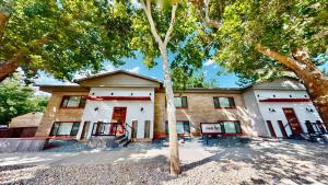 a building with a tree in front of it at Moab Flats #5 in Moab