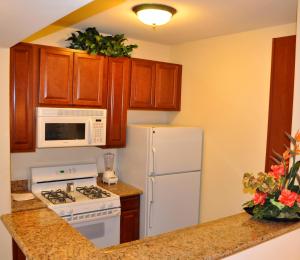 a kitchen with a white refrigerator and a white microwave at Club de Soleil All-Suite Resort in Las Vegas