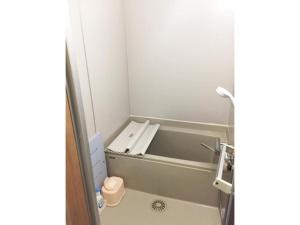 a bathroom with a bath tub with a toilet at Kohan no yado Kojima - Vacation STAY 34143v in Lake Toya