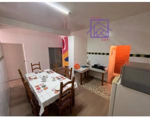 a dining room with a table with chairs and a television at Casa 205 in Tlaxcala de Xicohténcatl