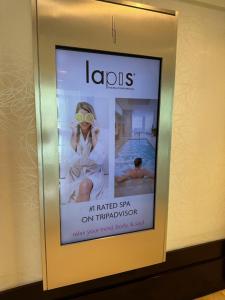 a framed picture of a woman wearing sunglasses in a bathroom at Fontainebleau Miami Beach,Tresor in Miami Beach