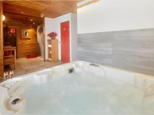 un bagno con grande vasca bianca di Chalet luxueux avec jacuzzi, sauna et WiFi aux Gets - FR-1-671-83 a Les Gets Altre 14 foto