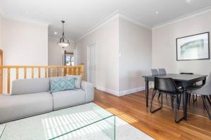 a living room with a couch and a table at Classic Elegance on The Hill in Newcastle