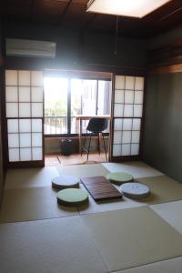 a room with four mats on the floor with a window at 平日限定割引実施中 1日1組限定の貸切一軒家 個室サウナ付き in Fujisawa