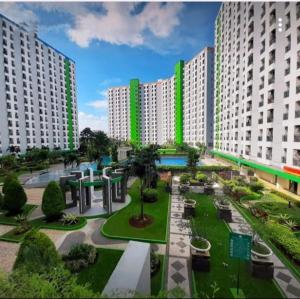 a view of a park with tall white buildings at Apartemen Green Lake View Ciputat by My Rooms in Pondokcabe Hilir