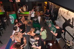 a group of people standing around a table with cake at Balcony Party Hostel - Adult Only +18 in Ao Nang Beach