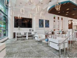 a lobby with white furniture and a table and chairs at The Luxe -Highrise, Balcony, Pool, City View! in Atlanta