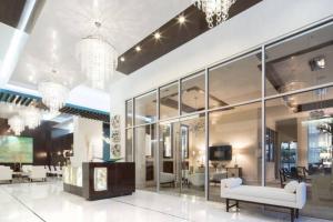 a large lobby with glass walls and chandeliers at The Luxe -Highrise, Balcony, Pool, City View! in Atlanta