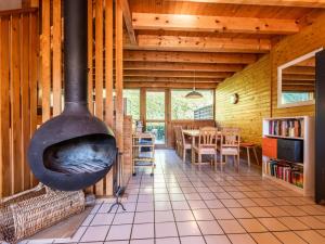 a large fireplace in a room with a dining room at Chalet Les Gets, 3 pièces, 8 personnes - FR-1-671-126 in Les Gets