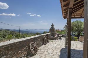 a stone wall with a view of the ocean at Villa Moraca in Parthenonas