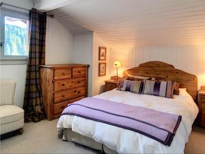 a bedroom with a large bed and a window at Chalet Les Gets, 8 pièces, 12 personnes - FR-1-671-141 in Les Gets