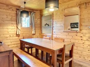 a wooden dining room with a wooden table and chairs at Chalet Les Gets, 8 pièces, 12 personnes - FR-1-671-141 in Les Gets