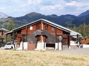 a building with a car parked in front of it at Appartement cosy avec Wifi, 4 pers, 300m des pistes à Crest-Voland - FR-1-733-141 in Crest-Voland