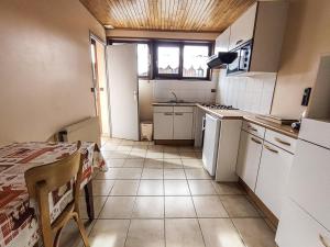 a kitchen with white appliances and a table and a window at Appartement Les Gets, 3 pièces, 5 personnes - FR-1-671-94 in Les Gets