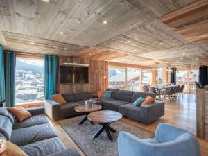 a living room with a couch and a table at Chalet de luxe avec jacuzzi, Wi-Fi et parking privé - FR-1-671-138 in Les Gets