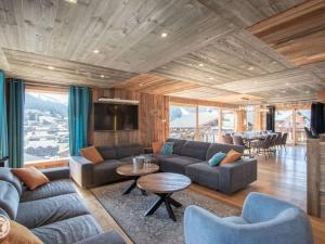 a living room with a couch and a table at Chalet Les Gets, 7 pièces, 12 personnes - FR-1-671-138 in Les Gets
