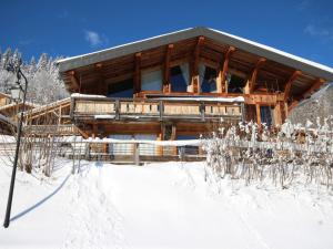 a log cabin in the snow with snow covered trees at Chalet Les Gets, 7 pièces, 12 personnes - FR-1-671-138 in Les Gets