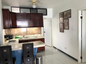 a kitchen with wooden cabinets and a counter top at Apartamento en excelente ubicación in Manta