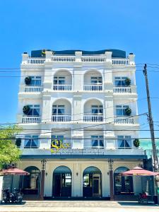 a large white building with a sign on it at Sky House Apartment in Tam Ky