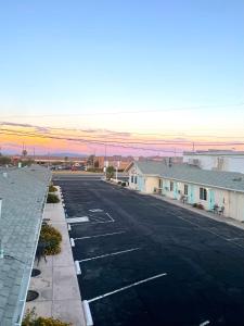 an empty parking lot in a town with a sunset at Howard Johnson by Wyndham Ridgecrest, CA in Ridgecrest