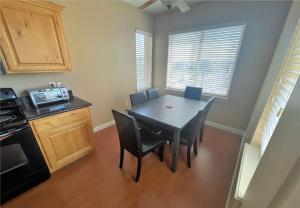 a dining room with a table and chairs and a kitchen at Deluxe Downtown Condo Close to Everything! in Salt Lake City