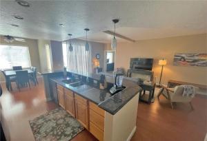 a kitchen with a counter top and a living room at Deluxe Downtown Condo Close to Everything! in Salt Lake City