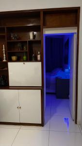 a room with a white cabinet and a blue light at Copacabana in Beach in Rio de Janeiro