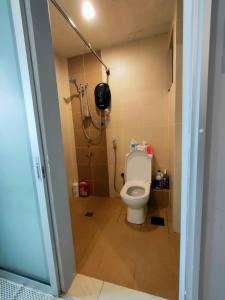 a bathroom with a toilet and a shower at D'Aqiela Homestay @ ITCC in Penampang